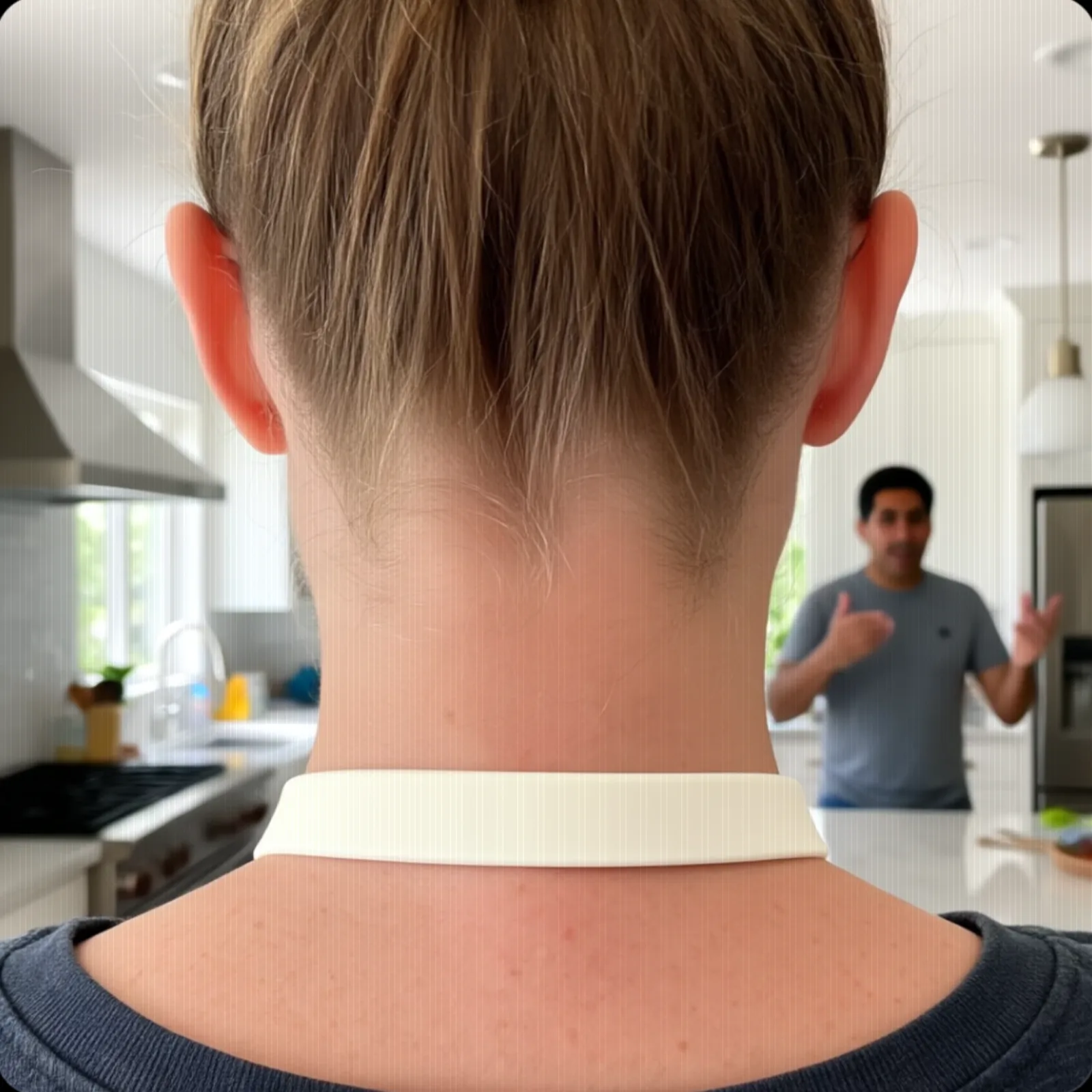 The view ahead of a person wearing Wha, facing another person across a room